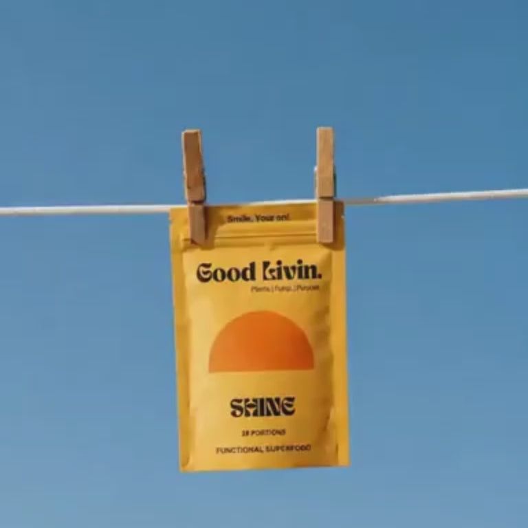 A bag of Shine hanging from a clothesline against a blue sky